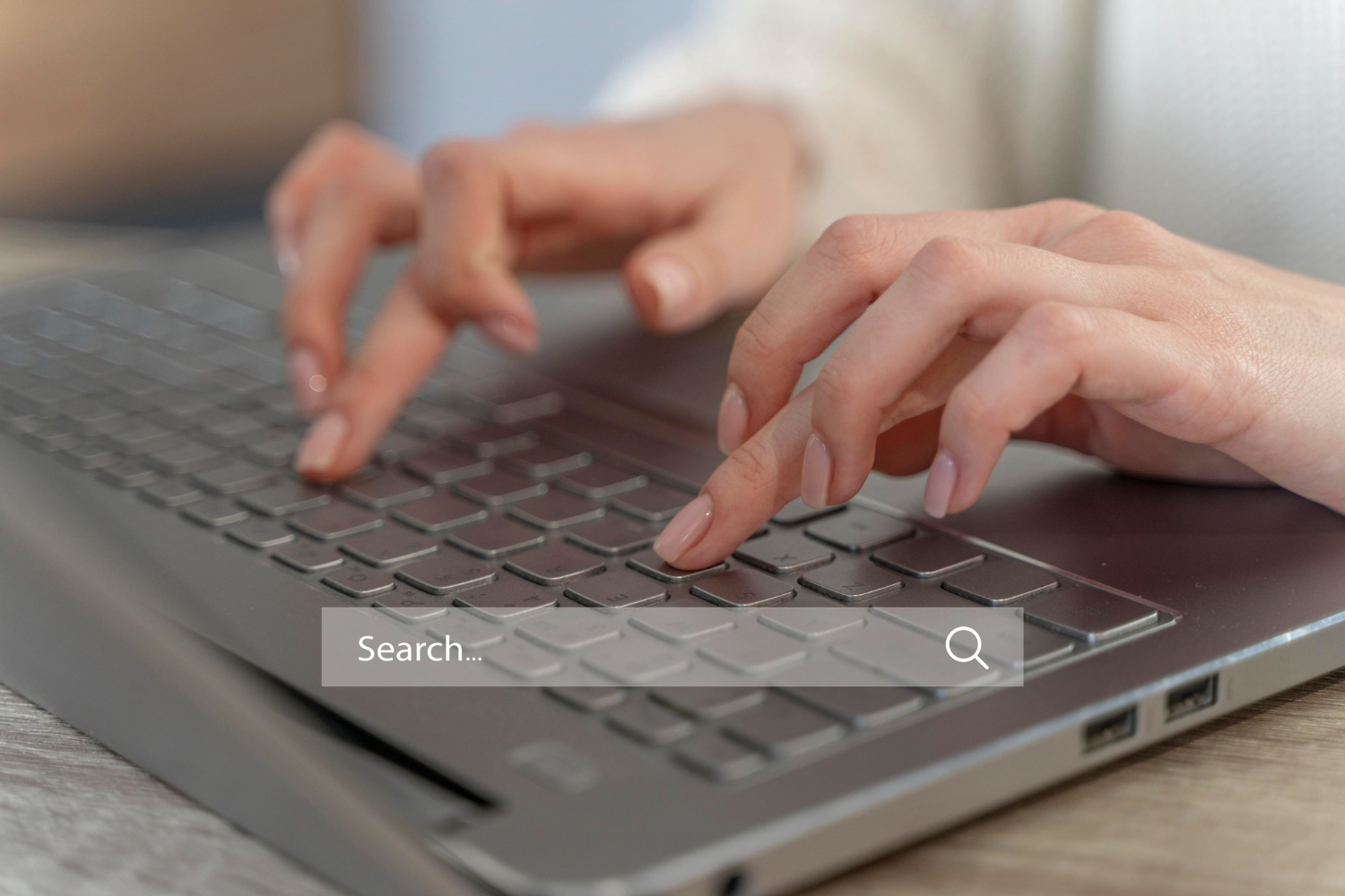 Hands using a laptop search bar for local SEO for small business and better visibility