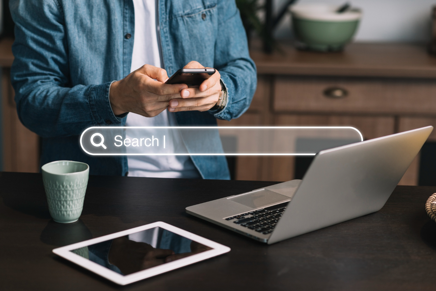 Person searching online on phone and laptop for local SEO for small business