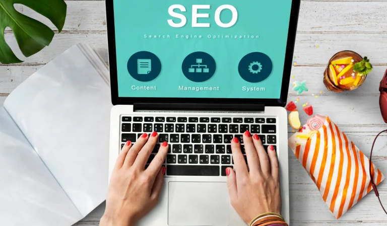 AI-first SEO specialists managing content and search optimization on a laptop